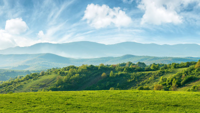 clouds sky mountains green hillside