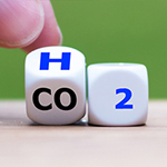 Letters on dice showing H from CO2