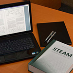 Steam book and laptop on desk